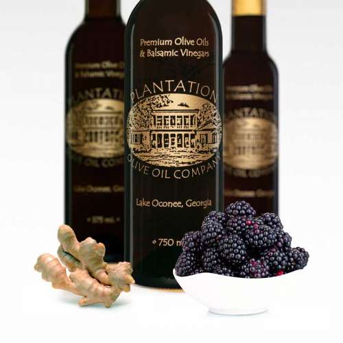 Photo showing fresh blackberries and ginger in front of three bottles of dark balsamic vinegar.